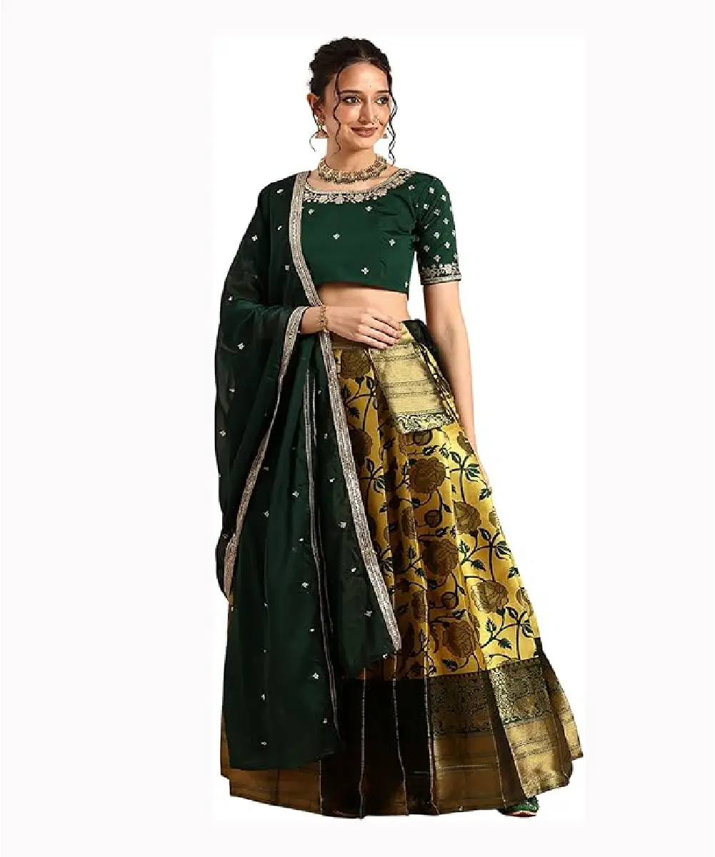 A woman is wearing an embroidered green blouse and a gold taffeta satin lehenga set.