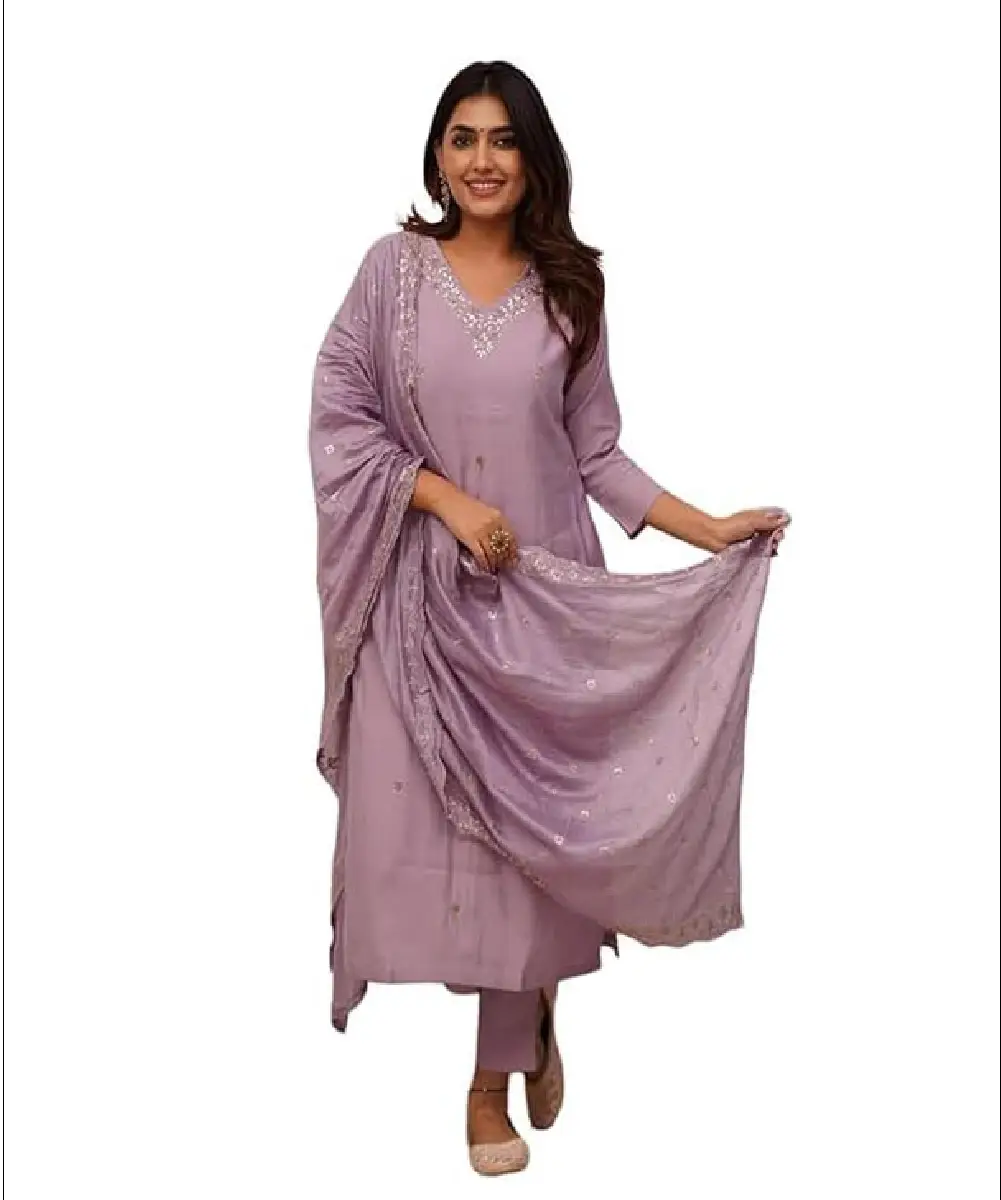 A woman wearing a vibrant red Anarkali-style kurti with gold print detailing, paired with matching pants and a decorative Nazmeen dupatta.