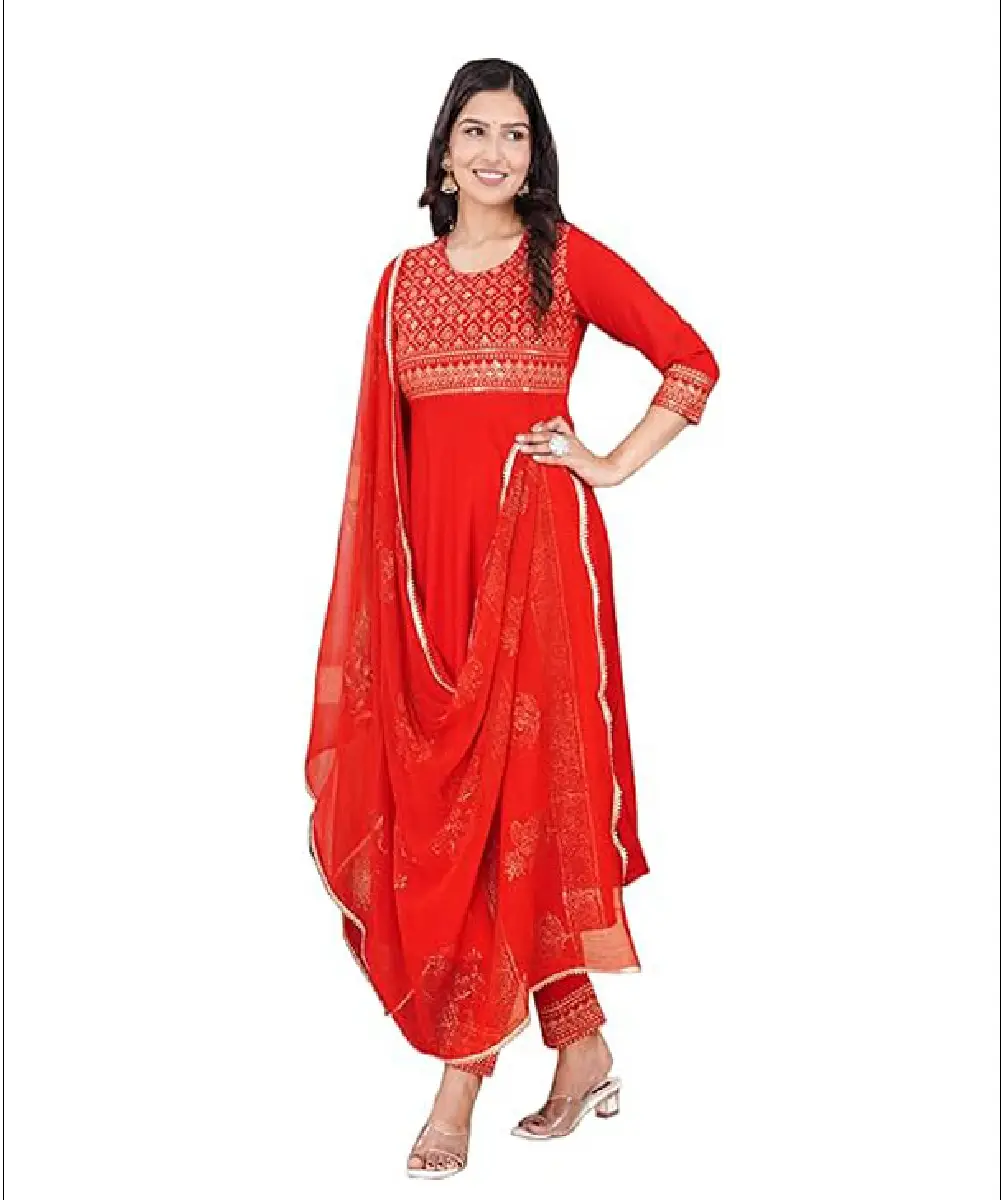 A woman wearing a bright red Anarkali-style kurti with gold print detailing, paired with matching pants and a decorative Nazmeen dupatta.