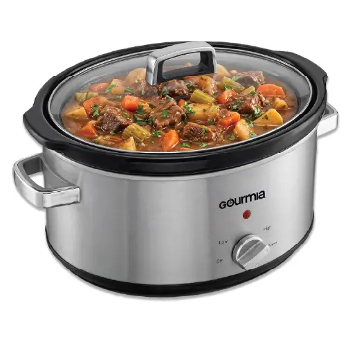 Front view of a Gourmia 7-quart stainless steel slow cooker filled with a savory stew, featuring a glass lid, side handles, and a manual control dial.