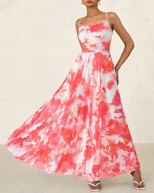 Woman wearing a white and hot pink abstract floral sleeveless maxi dress with a cowl neckline.