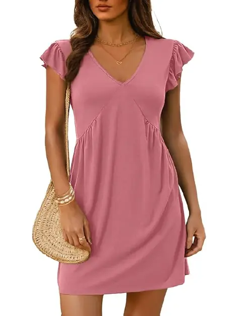Woman wearing a dusty rose pink V-neck short sleeve shift dress with ruffle flutter sleeves and a relaxed fit.