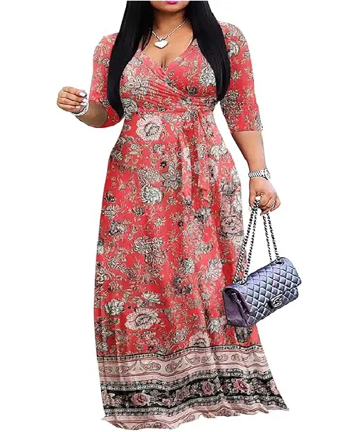 Woman wearing a red V-neck wrap maxi dress featuring an intricate floral print and a patterned hem border while carrying a quilted handbag.