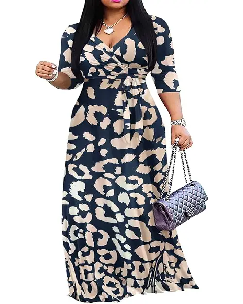 Woman wearing a dark navy blue and beige abstract animal print wrap maxi dress with three-quarter sleeves and a waist tie.