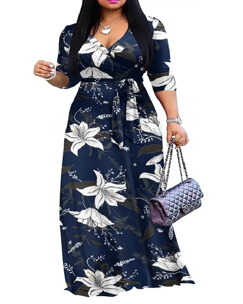 Woman wearing a deep navy blue and white large lily floral print wrap maxi dress with half sleeves and a tied waist.