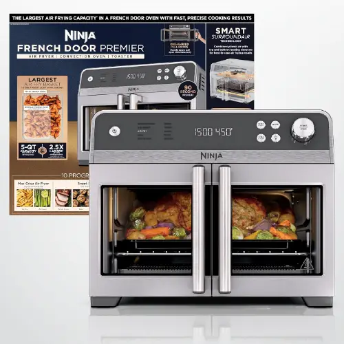 Stainless steel Ninja French Door Premier air fryer oven displaying roasted chicken and vegetables inside, with promotional packaging and cooking accessories shown in the background.