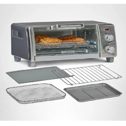 Black and stainless steel Black+Decker toaster oven with analog control dials, showing a wire basket of fried chicken inside, alongside detached baking pans and a wire rack.