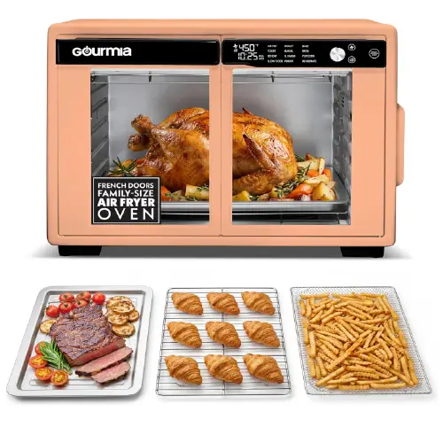 Peach-colored Gourmia family-size air fryer oven with French doors showing a whole roasted chicken inside, accompanied by a tray of steak, a wire rack of croissants, and a basket of french fries.