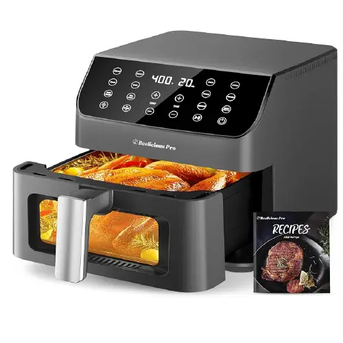 Dark grey Beelicious Pro air fryer with a top digital control interface, pull-out glass window drawer displaying a whole roasted chicken, and a recipe book beside it.