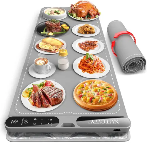 Grey silicone electric warming mat displayed with multiple dishes of food
