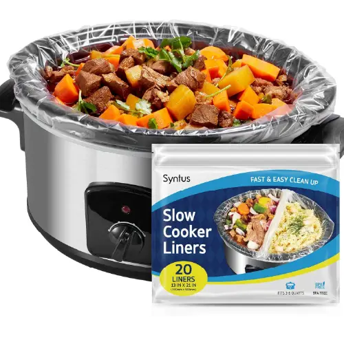 Slow cooker liners box next to a stainless steel slow cooker with stew