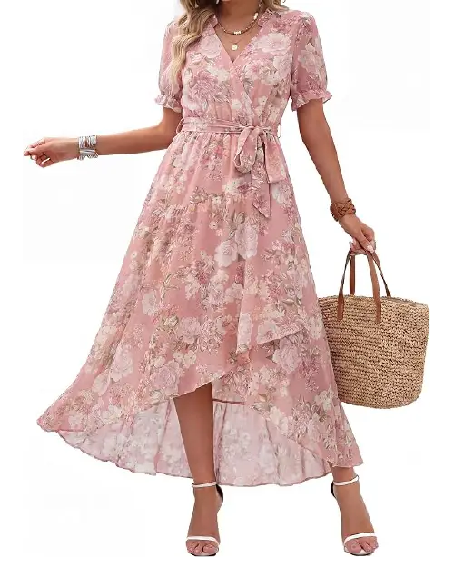 Model wearing a dusty pink floral chiffon wrap dress with short flutter sleeves and a high-low hem, paired with a woven tote bag.