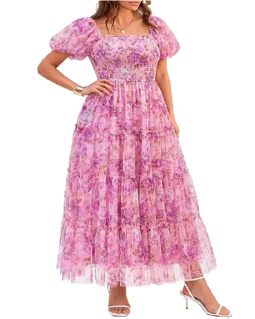 Model in a bright magenta pink floral mesh maxi dress featuring puff sleeves, a smocked bodice, and tiered skirt layers.