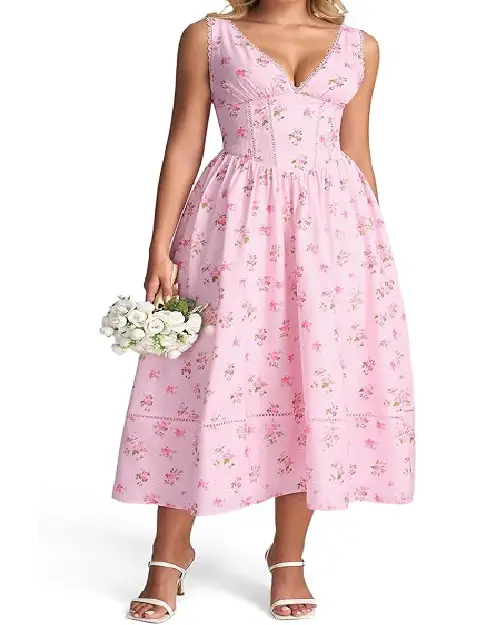 Woman holding white roses while wearing a light pink floral midi dress with a laced V-neckline and fitted corset-style waist.
