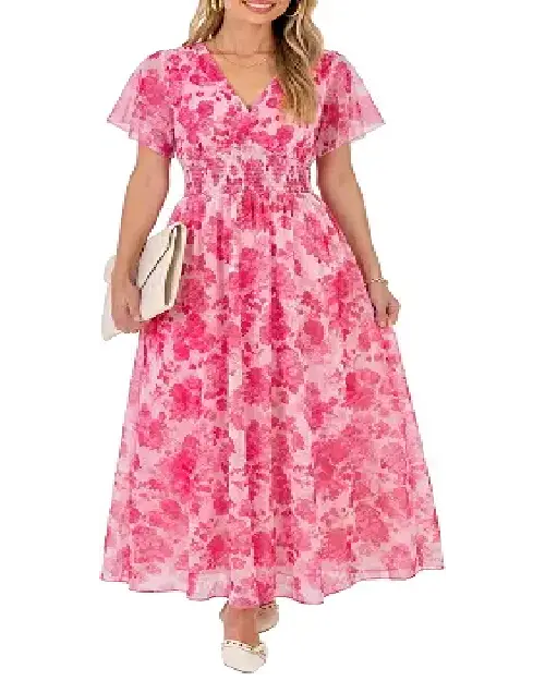 Woman holding a white clutch while wearing a bright hot pink floral maxi dress with flutter sleeves and a smocked waist.