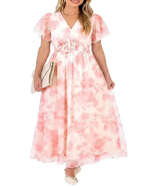 Model wearing a soft blush pink maxi dress with a watercolor rose print, flutter sleeves, and a smocked waistband.