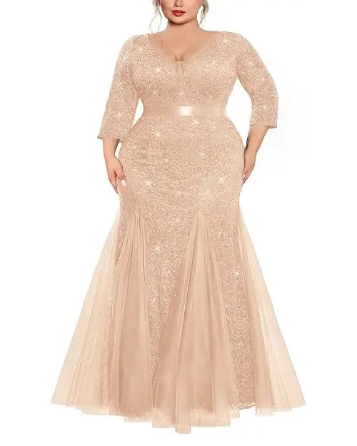 Champagne gold three-quarter sleeve mermaid gown covered in all-over glitter with tulle inset panels at the hem.