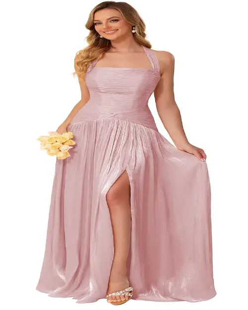 Dusty rose pink halter-neck formal maxi dress with pleated bodice and thigh-high slit holding yellow roses.
