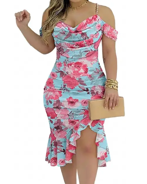 Woman posing in a sky blue floral midi dress featuring cold-shoulder cutouts, pearl strap accents, cowl neck, and a side-slit ruffle hem.