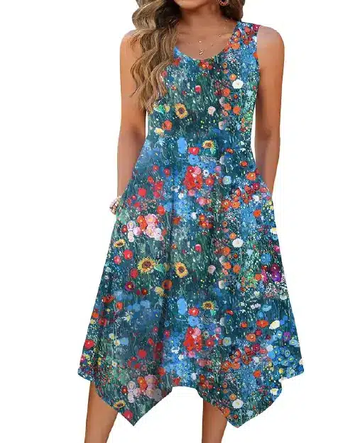 Model wearing a sleeveless teal blue midi dress printed with colorful wildflowers, featuring a relaxed scoop neck and an handkerchief style hem.
