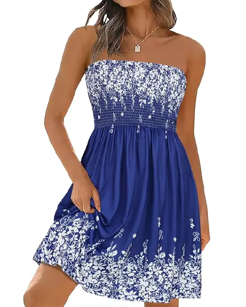 Woman wearing a royal blue strapless dress with white floral prints clustered along the smocked bodice and hemline.