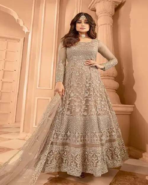 Taupe beige georgette Anarkali gown richly detailed with intricate all-over embroidery and a matching sheer dupatta.