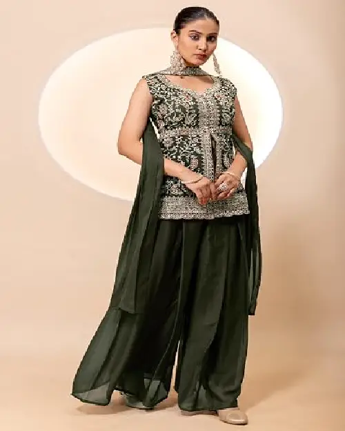 Dark green sleeveless peplum kurti with intricate silver embroidery paired with flowing sharara pants and matching scarf.