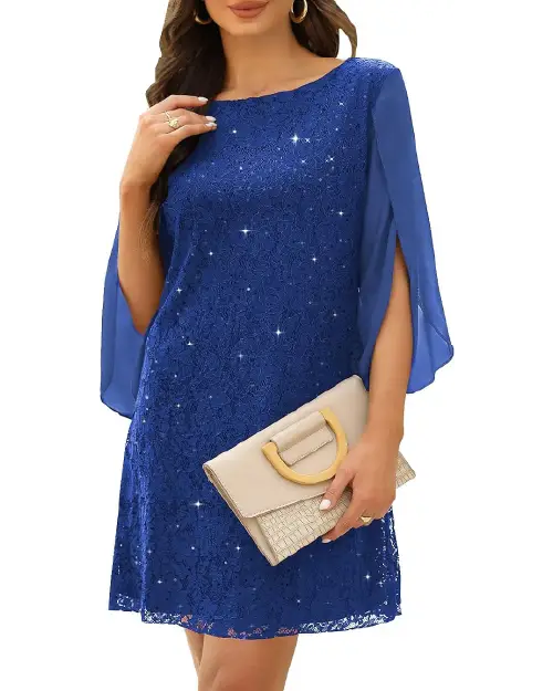Royal blue lace cocktail dress with split sleeves and sequin accents holding a clutch.