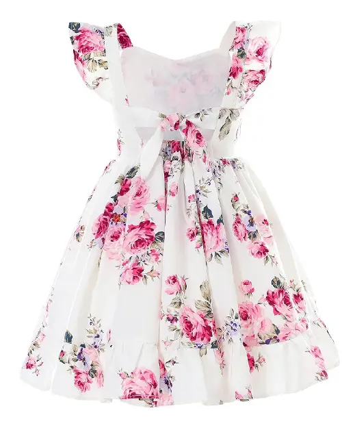 White flora dress featuring a bold pink rose print, back tie-bow, and ruffled cap sleeves.