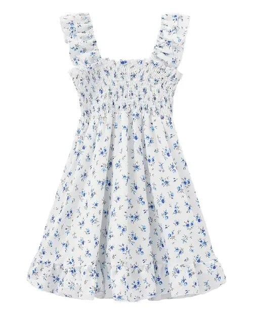 White flora dress featuring a blue ditsy floral print, a smocked bodice, ruffled straps, and a ruffled hem.