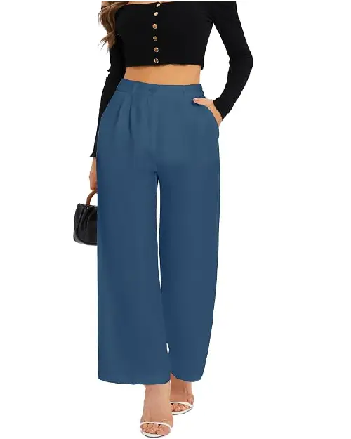 A person wearing deep blue high-waisted wide-leg work pants for women with front pleats, side pockets, and a button closure, holding a small black handbag.