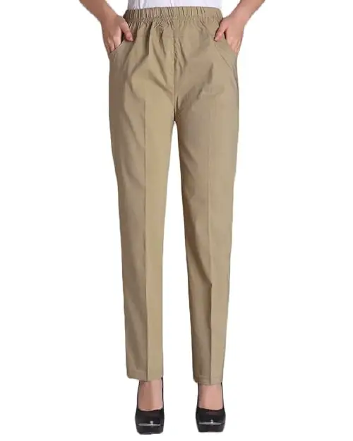 A person wearing khaki straight-leg work pants for women featuring an elastic waistband and front pocket details.