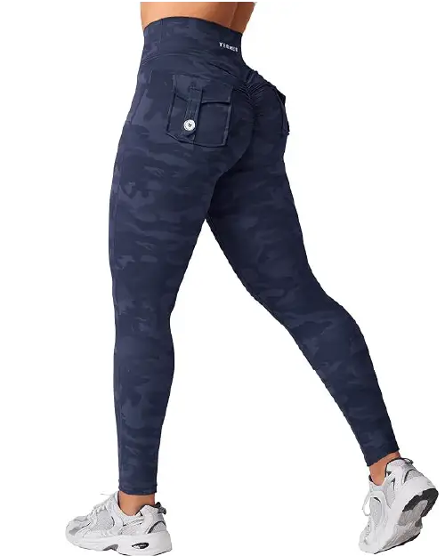 A person wearing dark navy blue camouflage print athletic leggings for women featuring a high waist and utility cargo pocket details.