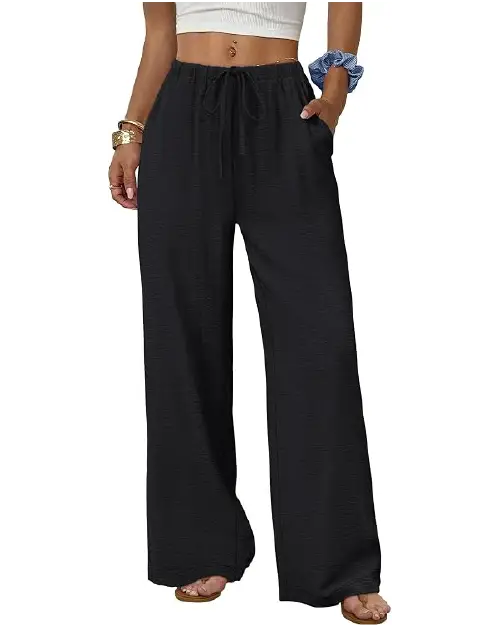 Black casual wide-leg trousers for women featuring a drawstring waistband, side pockets, and a soft textured fabric, paired with a white top and sandals.