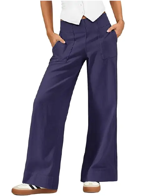 Navy blue relaxed wide-leg work pants for women featuring prominent front patch pockets, a high-waisted fit, and wide hems, paired with casual sneakers.