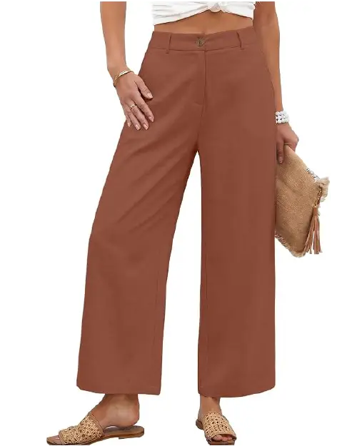 Rust brown high-waisted wide-leg trousers for women featuring a clean button closure, smooth fabric drape, and side pockets, paired with woven sandals.