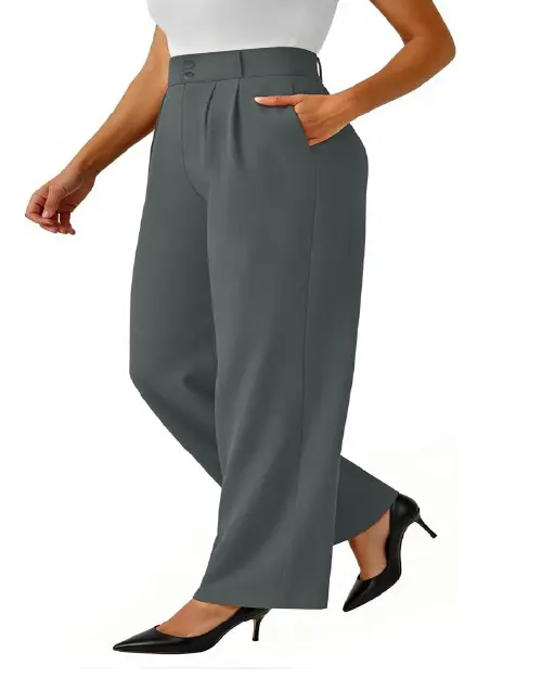 A person wearing dark gray high-waisted wide-leg work pants for women featuring front pleats, side pockets, and a button waistband.